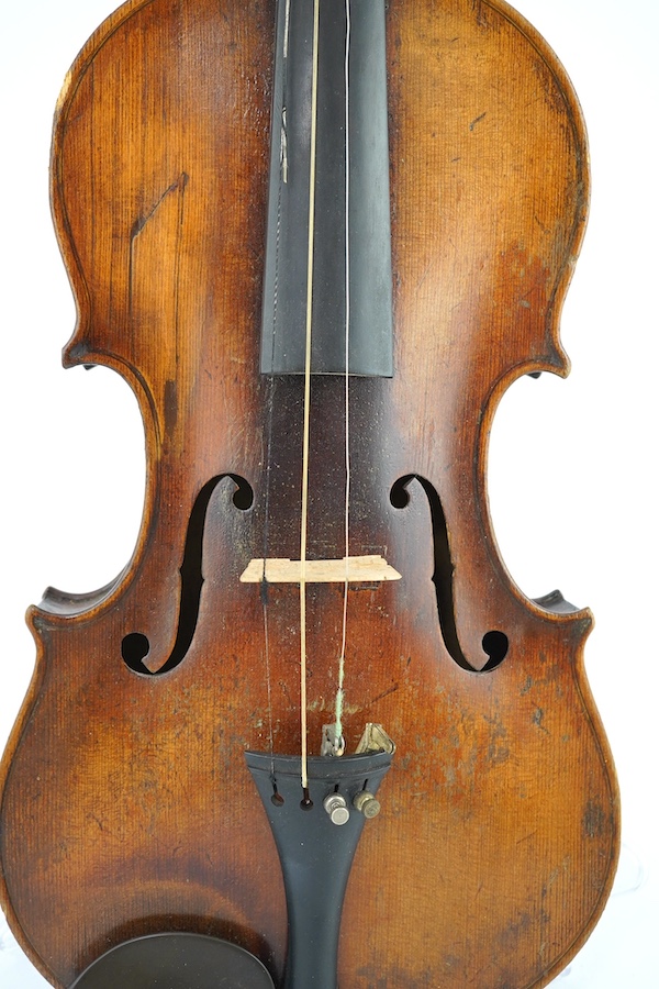 A late 19th century German Nuremberg school violin c.1880, Stradivarius pattern with a finely carved scroll and a large 14.25 inch body, together with a fully mounted German octagonal bow, contained within a contemporary